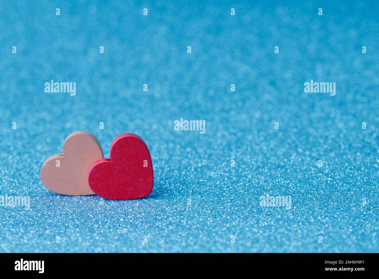 Pink and red wooden  hearts on a blue background. Valentine`s day holiday card Stock Photo
